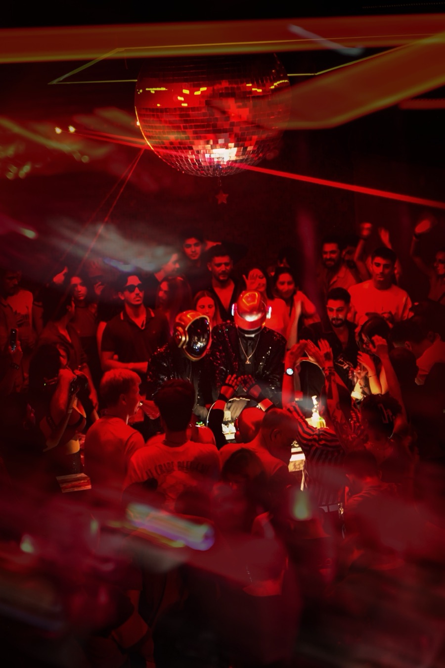 ALIVE performing under a red disco ball